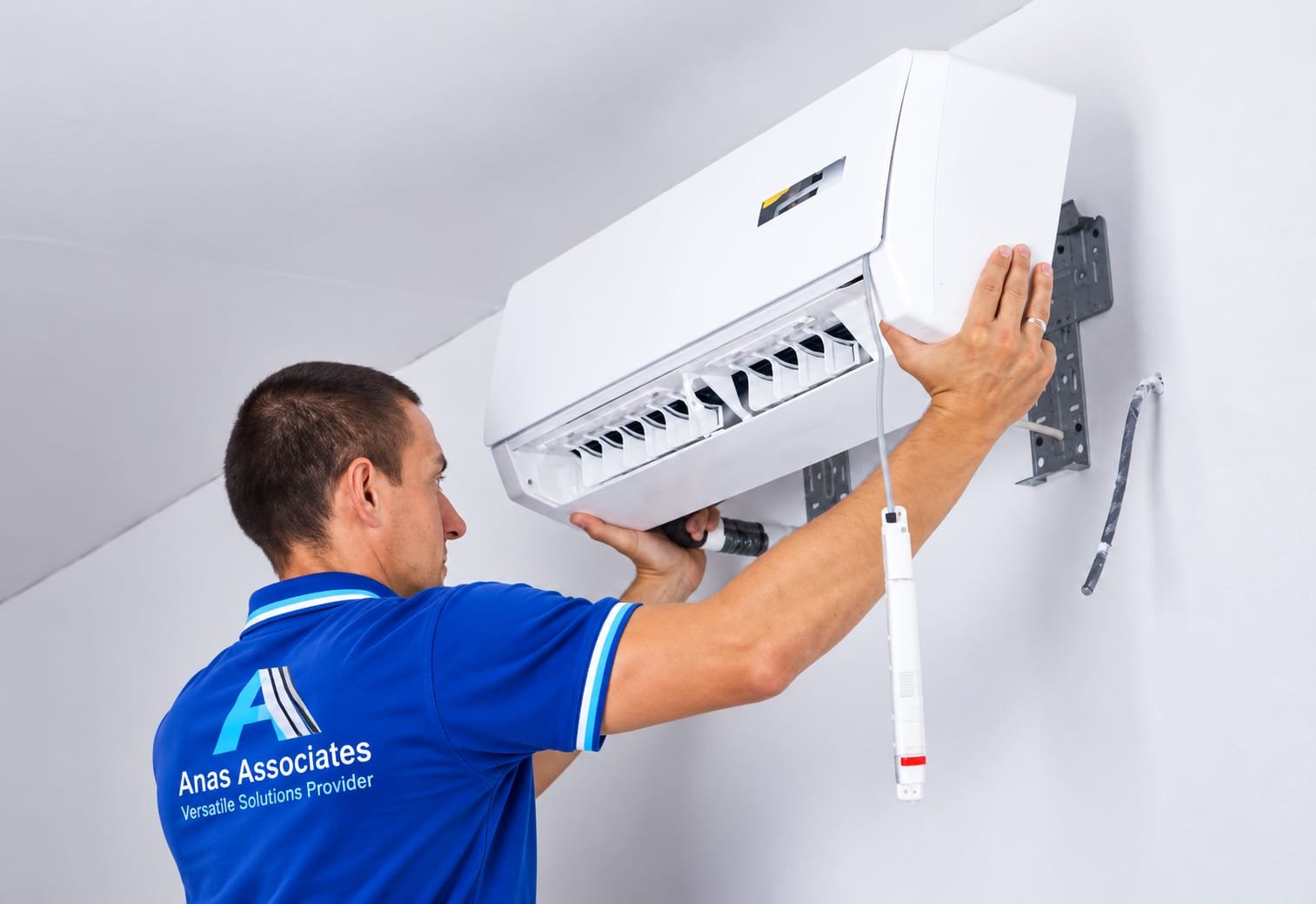 Service technician using tools for AC diagnosis on domestic wall unit